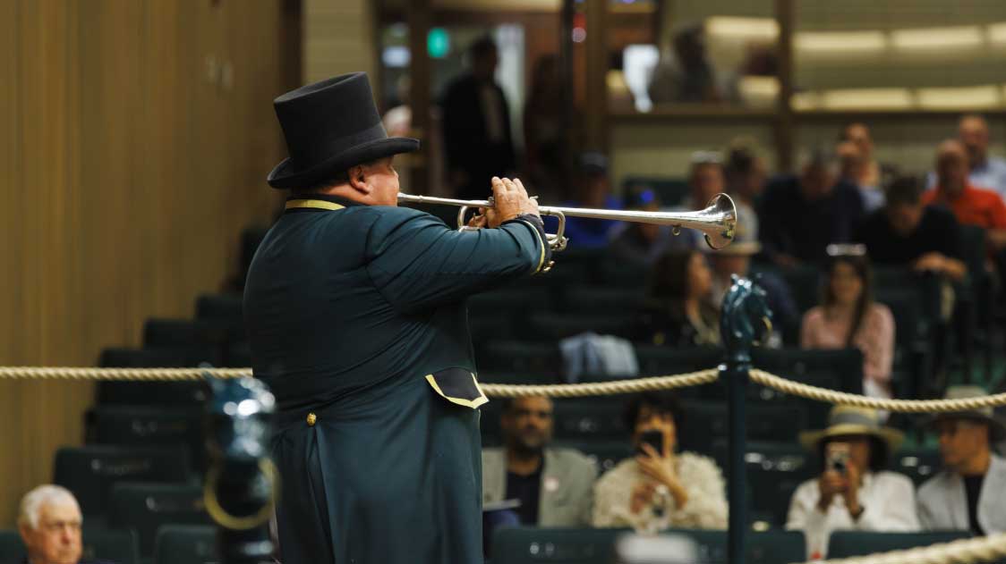 Keeneland bugler playing inside sales arena