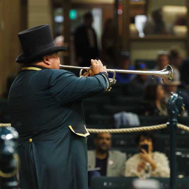 Keeneland bugler playing inside sales arena